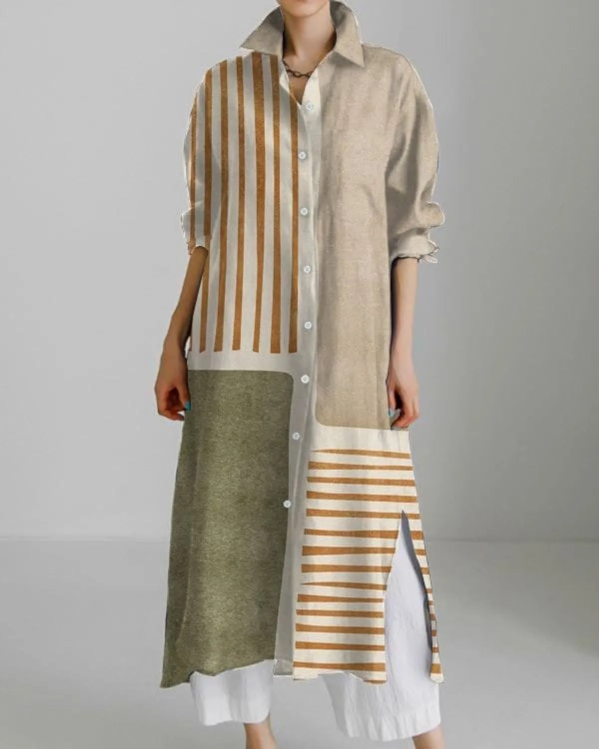 A long shirt dress with a combination of striped patterns in beige, green, and white colors, featuring a collar and 3/4 sleeves.
