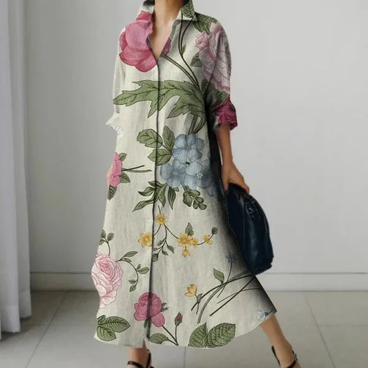 A person wearing a multicolor linen blend long dress with a floral pattern, featuring three-quarter sleeves and a V-neck.